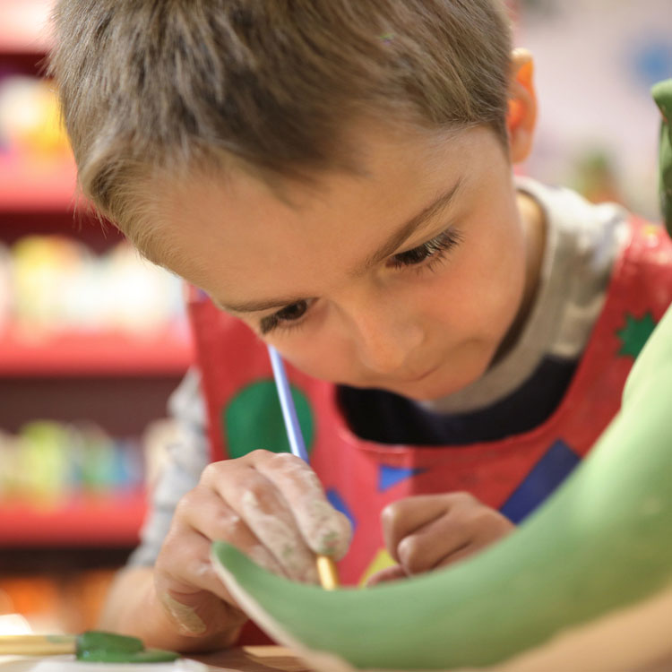 child concentrating on painting