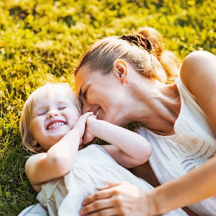 mother and child happy in grass